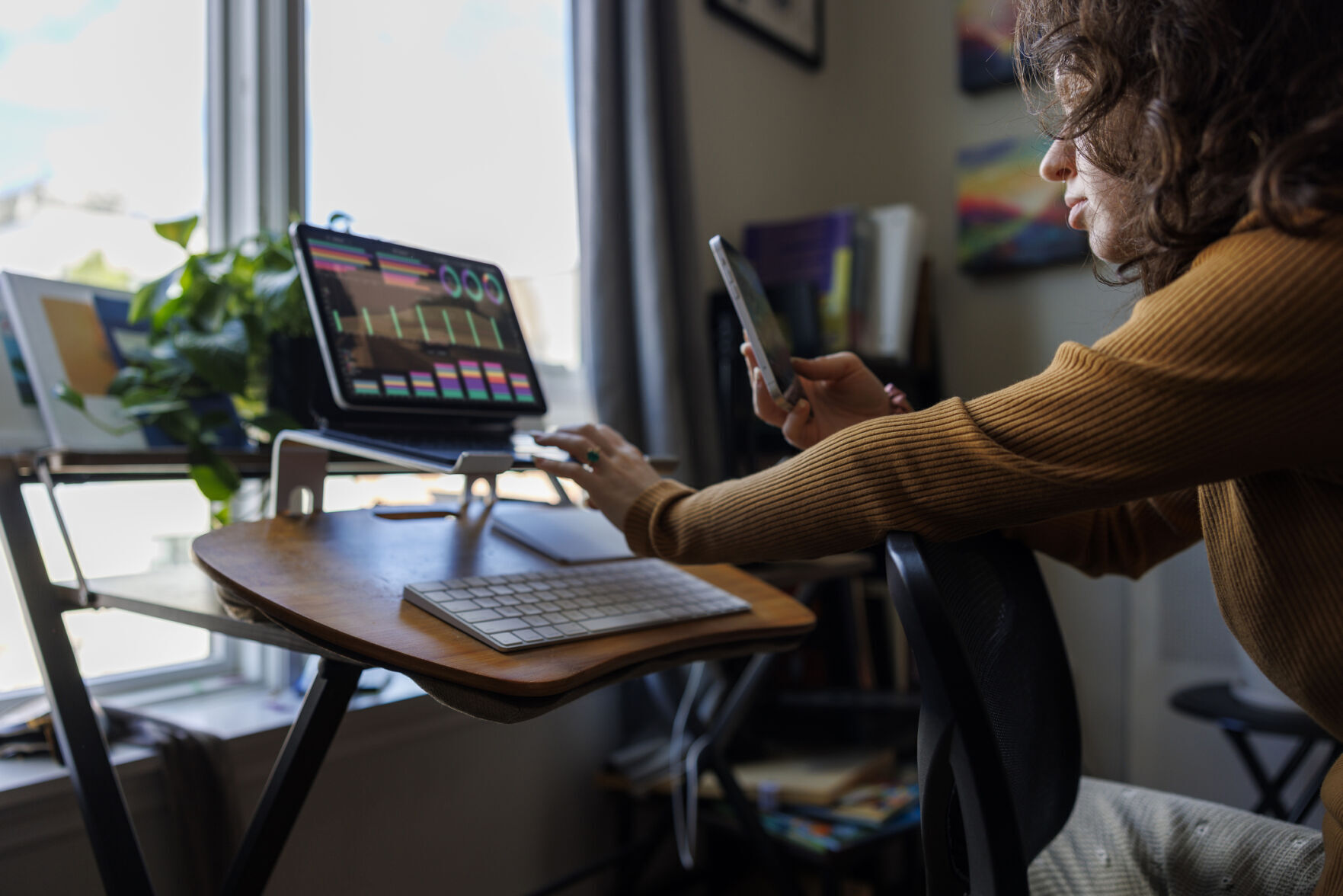 Financial online consultation: female adviser chatting with her clients and checking currency charts on her laptop from home